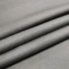 A close-up view of gray fabric with visible texture and folds. Náhled obrázku produktu