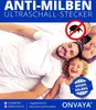 A family lying on a bed, smiling. Produktbild-Vorschau