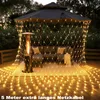 Outdoor patio area at dusk, decorated with string lights under a gazebo. Náhled obrázku produktu