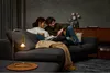 A couple relaxing on a couch with a lamp. Anteprima dell’immagine prodotto