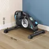 A mini exercise bike is shown on a wooden floor against a wall. Náhľad obrázku produktu