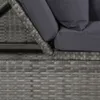A close-up view of the corner of a grey rattan sofa bed with dark grey cushions. Podgląd zdjęcia produktu