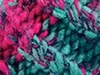 A close-up, textured view of yarn or fabric with intertwined pink and teal strands. Produktbild-Vorschau