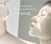 A close-up profile of a woman's face with her eyes closed, appearing relaxed, with a hand holding a clear bottle of product in the upper left corner. Text overlays the image. Produktbild-Vorschau