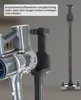 A close-up of a vacuum cleaner handle and charging station, with a full charging station in the background. Produktbild-Vorschau