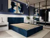 A bedroom with a dark blue upholstered bed frame and slatted base, flanked by white nightstands. Two abstract blue paintings hang on the dark blue wall above the bed. Náhľad obrázku produktu
