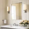 A modern bathroom vanity area with a mirror, sink, faucet, towel, and flowers. Produktbild-Vorschau