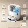 A 3D render of a white robot vacuum cleaner with transparent water tanks, showcasing its features with overlaid icons and text. Produktbild-Vorschau