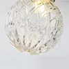 A close-up view of a clear, textured glass lampshade. Produktbild-Vorschau
