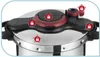 Close-up of the lid of a pressure cooker, highlighting safety features with lock icons. Podgląd zdjęcia produktu
