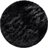 A round, black, shaggy rug shown from a top-down perspective. Anteprima dell’immagine prodotto