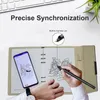 A person is using a smart pen to draw on a notebook, with a smartphone displaying the same drawing next to it. The scene is set on a desk with a keyboard and a plant in the background. Náhľad obrázku produktu
