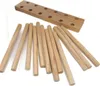 A wooden base with holes and several wooden dowels are arranged on a white background. Produktbild-Vorschau