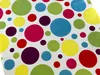 A close-up, top-down view of a colorful, polka-dot patterned tablecloth. Náhľad obrázku produktu