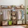 A wooden garment rack with clothing, bags, boxes, and boots displayed. Produktbild-Vorschau