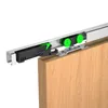 A close-up view of a sliding door hardware system attached to a wooden door. Produktbild-Vorschau
