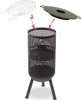 A black metal fire pit with three legs, shown with a grill grate and a lid above it. Produktbild-Vorschau