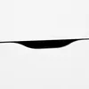 A close-up abstract shot of a black drawer pull on a white surface. Produktbild-Vorschau