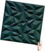A hand holding a dark green 3D wall panel. Podgląd zdjęcia produktu
