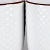 Close-up view of the textured surfaces of two white ceramic cups with brown rims. Podgląd zdjęcia produktu