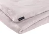 A close-up view of a folded pink muslin duvet cover with a small black tag attached. Produktbild-Vorschau