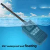 A walkie-talkie is partially submerged in water, with the sky and clouds in the background. Voir les images du produit