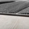 A close-up view of the edge of a rug with a geometric pattern. Produktbild-Vorschau