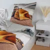 A bed with bedding featuring a construction vehicle motif, next to a nightstand. Náhľad obrázku produktu