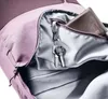 Close-up view of the interior of a backpack, showing a wallet and keys in a zippered pocket. Produktbild-Vorschau