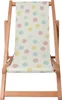 A wooden deck chair with a pastel polka dot fabric. Produktbild-Vorschau