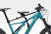 A teal mountain bike with a black child seat attached in front of the rider's seat. Produktbild-Vorschau