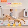 A child is playing on a wooden climbing set indoors. Náhled obrázku produktu