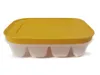 A yellow lidded ice cube tray with white compartments, shown from the side against a white background. Produktbild-Vorschau