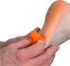 A close-up shot of a person's hand holding an orange massage tool against a person's heel. Voir les images du produit