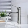 A modern chrome faucet with water flowing into a sink, set against a tiled wall. Podgląd zdjęcia produktu