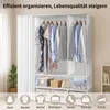 A white fabric wardrobe with clothes hanging and storage boxes inside. Náhľad obrázku produktu