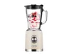 A beige stand mixer with a glass pitcher filled with berries and cream, set against a white background. Produktbild-Vorschau