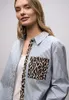 A woman is shown from the chest up, wearing a striped shirt. Produktbild-Vorschau