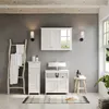 A well-lit bathroom scene featuring a white vanity cabinet with a sink, a medicine cabinet, a ladder with towels, and a wooden stool. Podgląd zdjęcia produktu