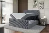 A modern bedroom with a grey velvet boxspring bed with storage, a mattress and topper are lifted to reveal the storage compartment. The room has a large window with sheer curtains, wooden wall paneling, and abstract art on the wall. Produktbild-Vorschau