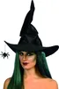 A woman wearing a witch hat and green wig, with a spider accessory. Produktbild-Vorschau