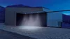 A modern building entrance at night, illuminated by spotlights. Náhľad obrázku produktu