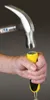 A hand holding a chisel with a hammer poised to strike the end. Voir les images du produit