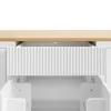 A close-up view of an open kitchen island drawer with a fluted front, revealing the interior and drawer slides. Produktbild-Vorschau