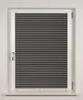 A closed window with dark gray pleated blinds. Produktbild-Vorschau