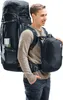 A man is wearing a large backpack and a smaller detachable backpack. Anteprima dell’immagine prodotto