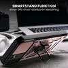 A close-up of a phone case with a ring stand, placed on a desk with a laptop and headphones in the background. Produktbild-Vorschau