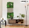 A modern living room with a vertical plant wall and a wooden media console. Produktbild-Vorschau