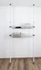 A white wall and wooden floor with a two-tiered telescopic storage system. Produktbild-Vorschau