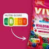 A marketing image showing a Nutri-Score graphic pointing to a package of VIVIL Waldfrucht Multivitaminbonbons. Produktbild-Vorschau